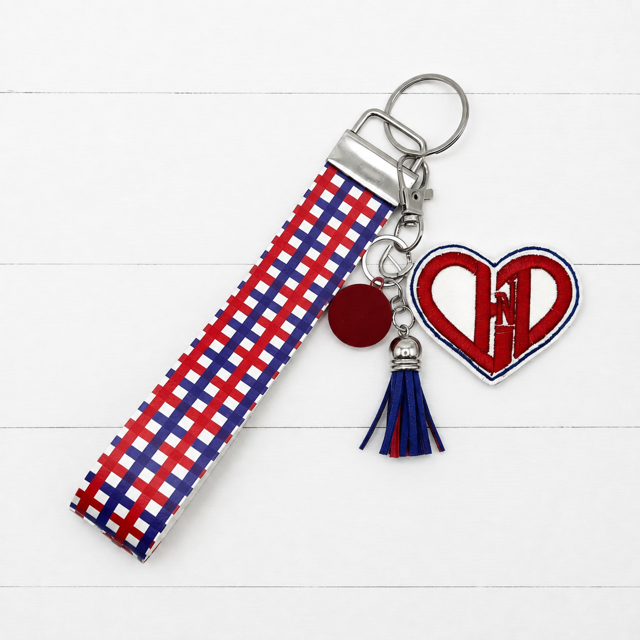 Congenital Heart Defect Keychain and Wristlet on clean white painted wood background