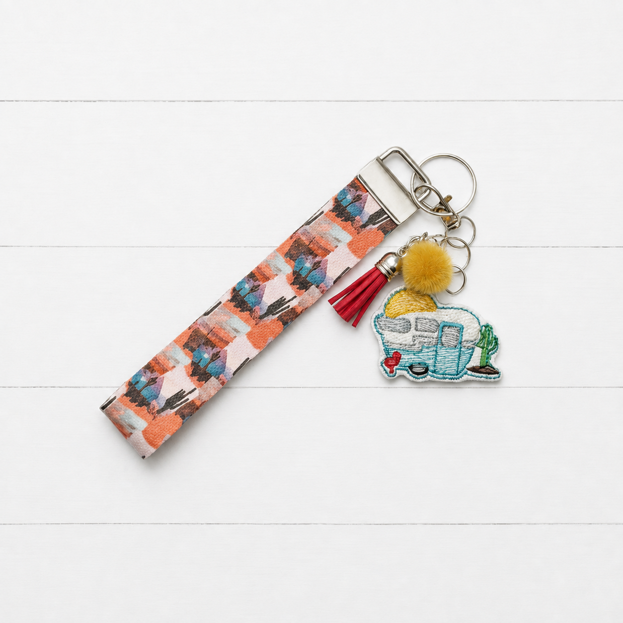 Desert Camper Keychain and Wristlet on clean white painted wood background