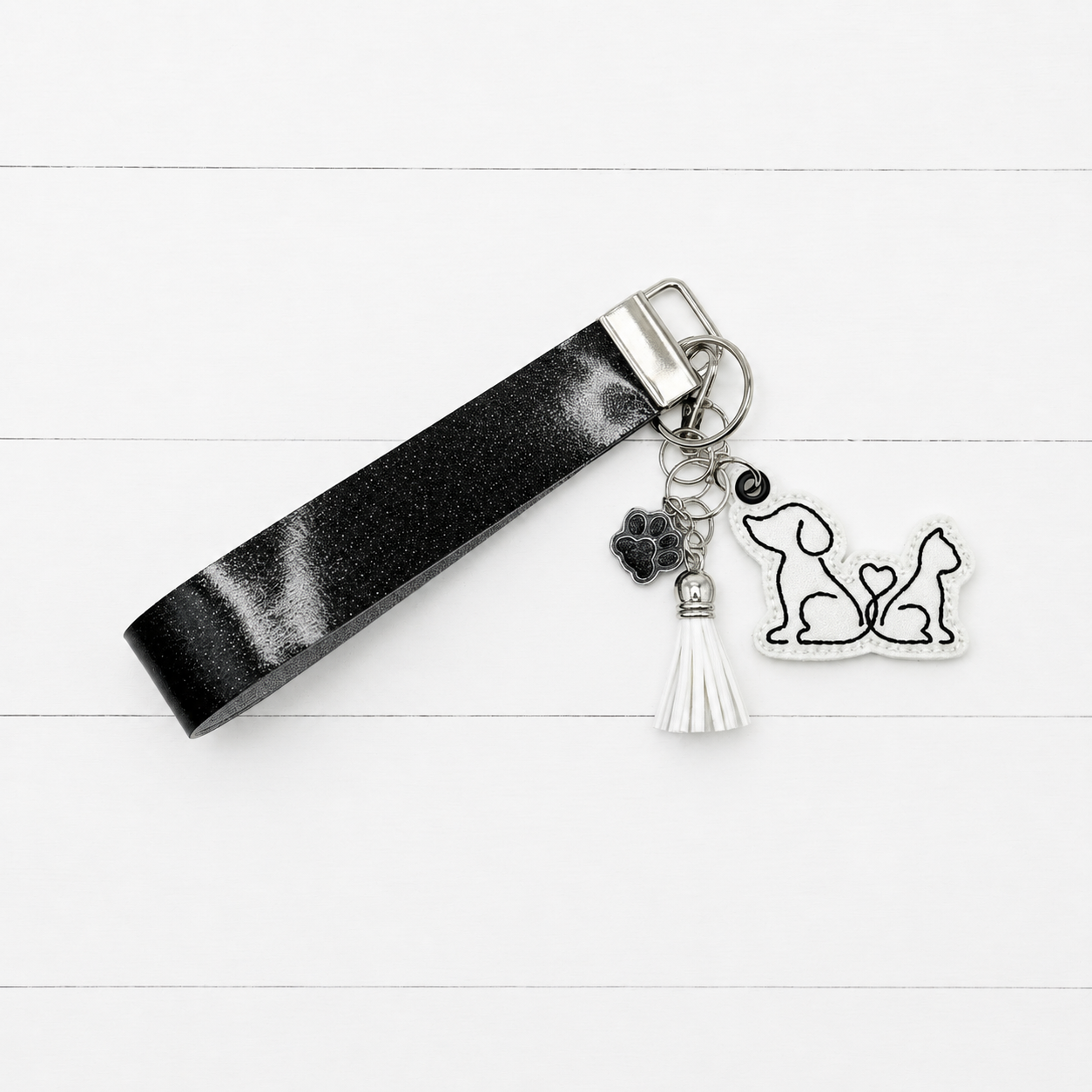 Dog and Cat Heart Tail Keychain and Wristlet on clean white painted wood background