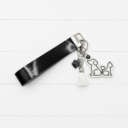 Dog and Cat Heart Tail Keychain and Wristlet on clean white painted wood background