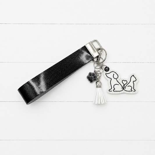 Dog and Cat Heart Tail Keychain and Wristlet on clean white painted wood background