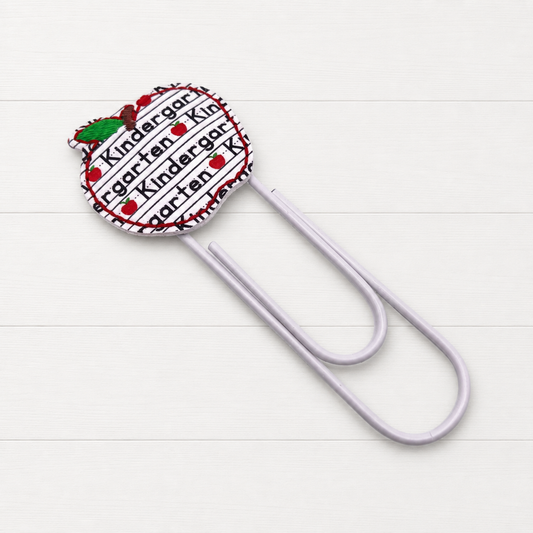 Grade Level Apple Oversized Paper Clip on a clean white wood background