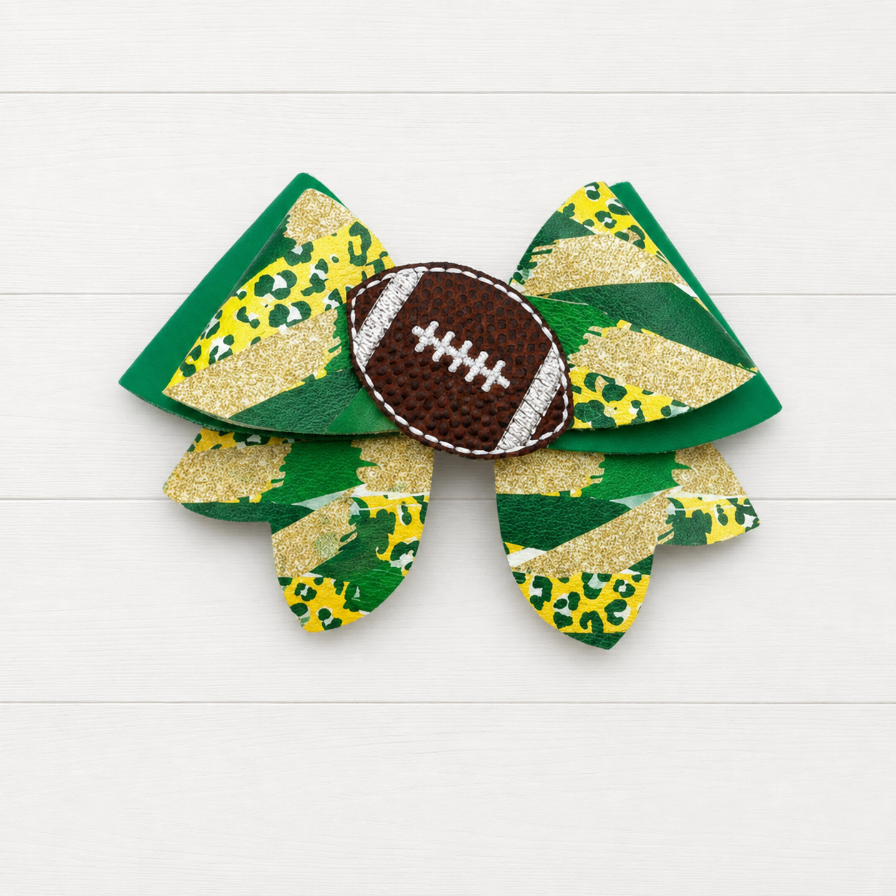 Green and Yellow Football Heart Bow on a clean white wood background