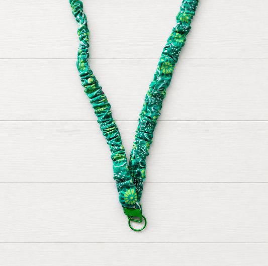 Green Flower Power Scrunchie Lanyard on a clean white wood background