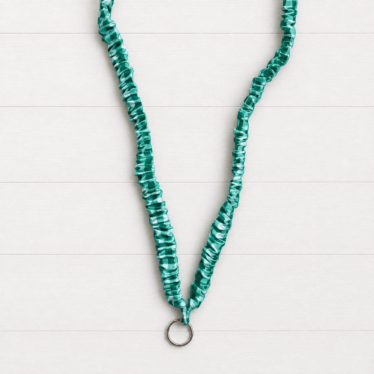 Green Gingahm Scrunchie Lanyard on a clean white wood background
