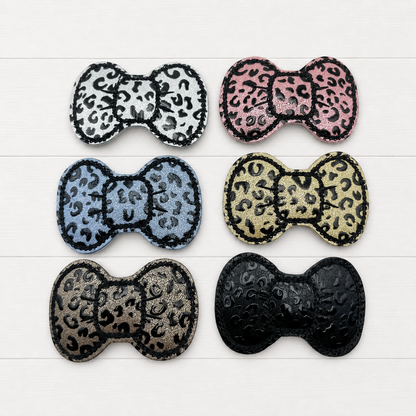 Leopard Hair Bow Clips on a clean white wood background