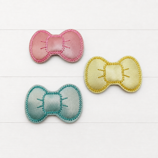 Pink, Blue and Yellow Pastel Hair Bow Clips on a clean white wood background