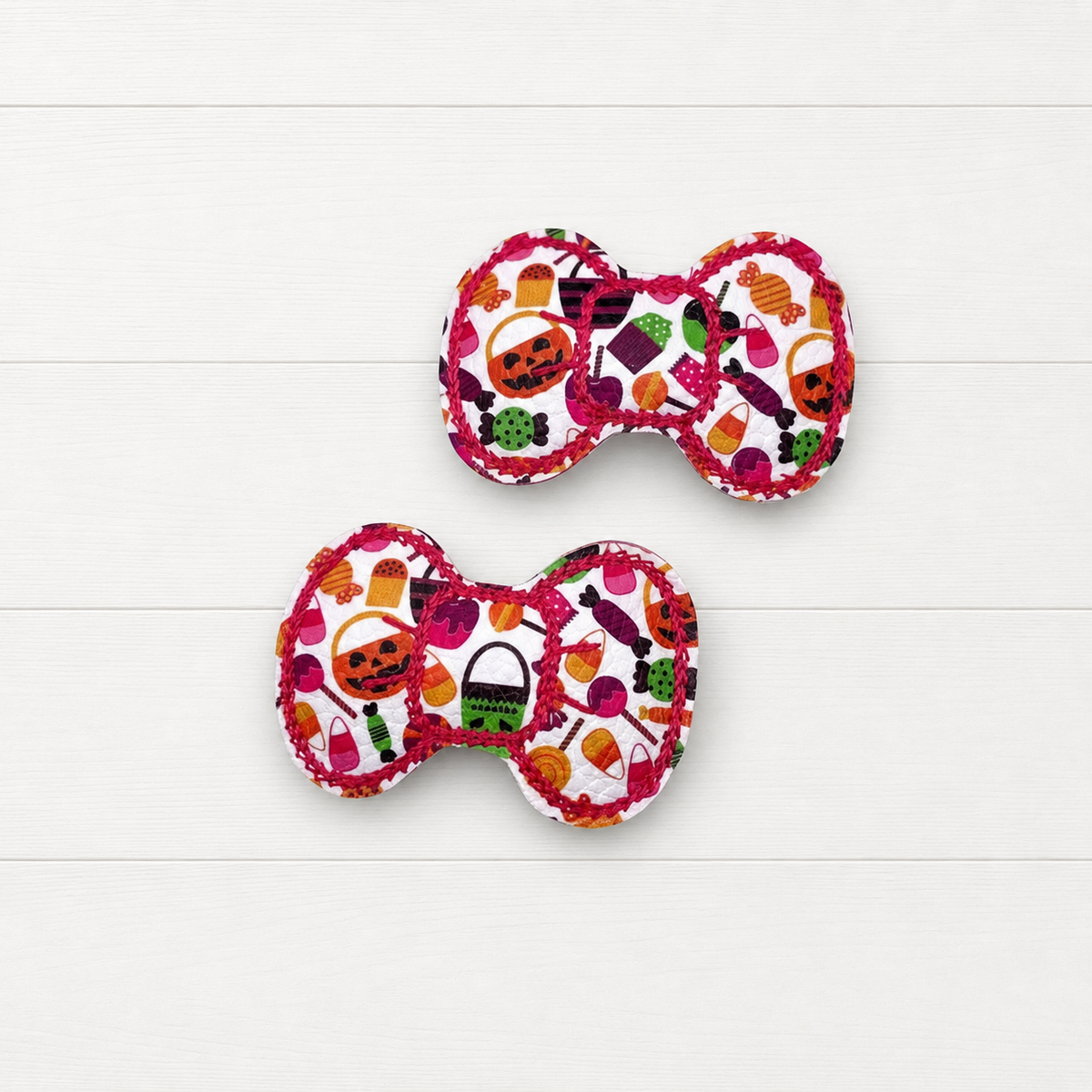 Halloween bow snap clips on a clean white wood background