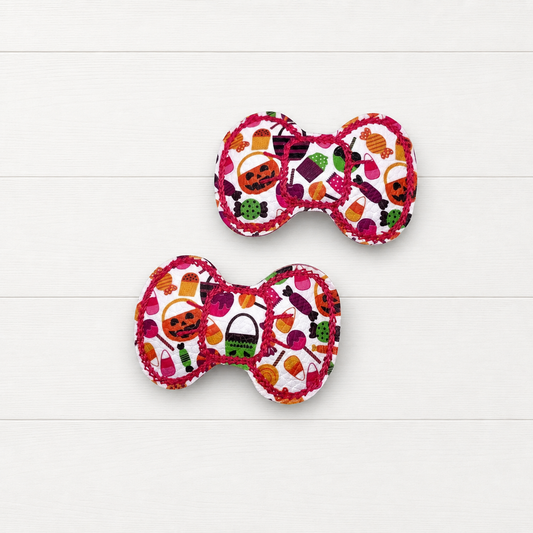 Halloween bow snap clips on a clean white wood background