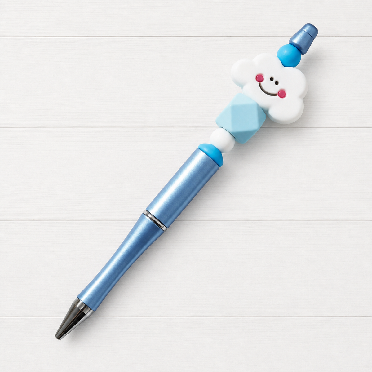 Happy Cloud Beaded Pen on a clean white wood background