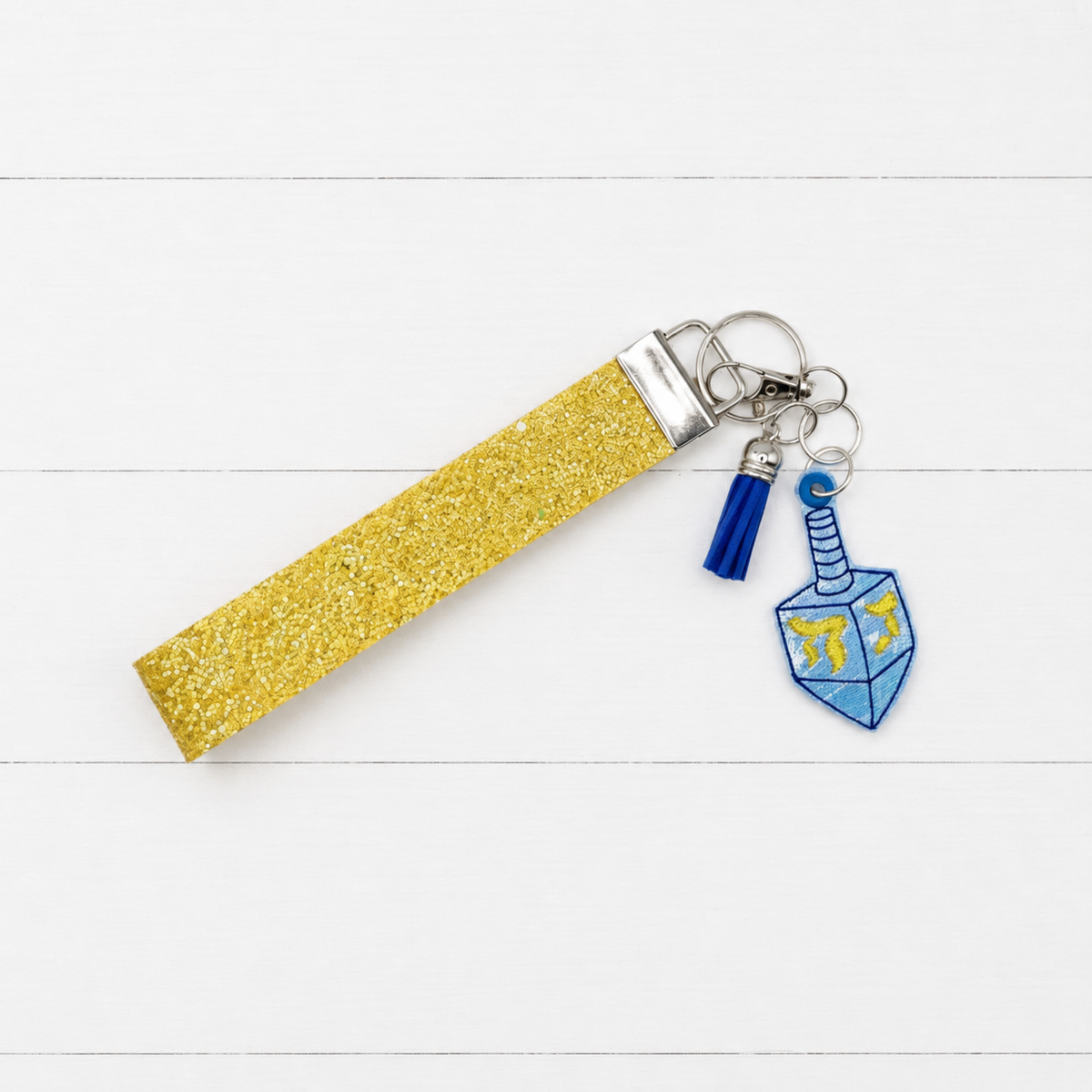 Dreidel Keychain and Wristlet — clean white wood primary image