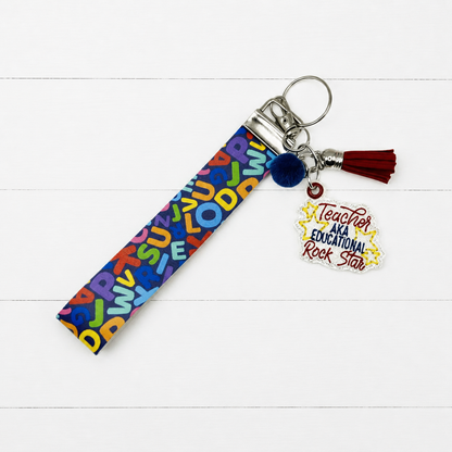 Educational Rockstar Keychain and Wristlet — clean white wood primary image