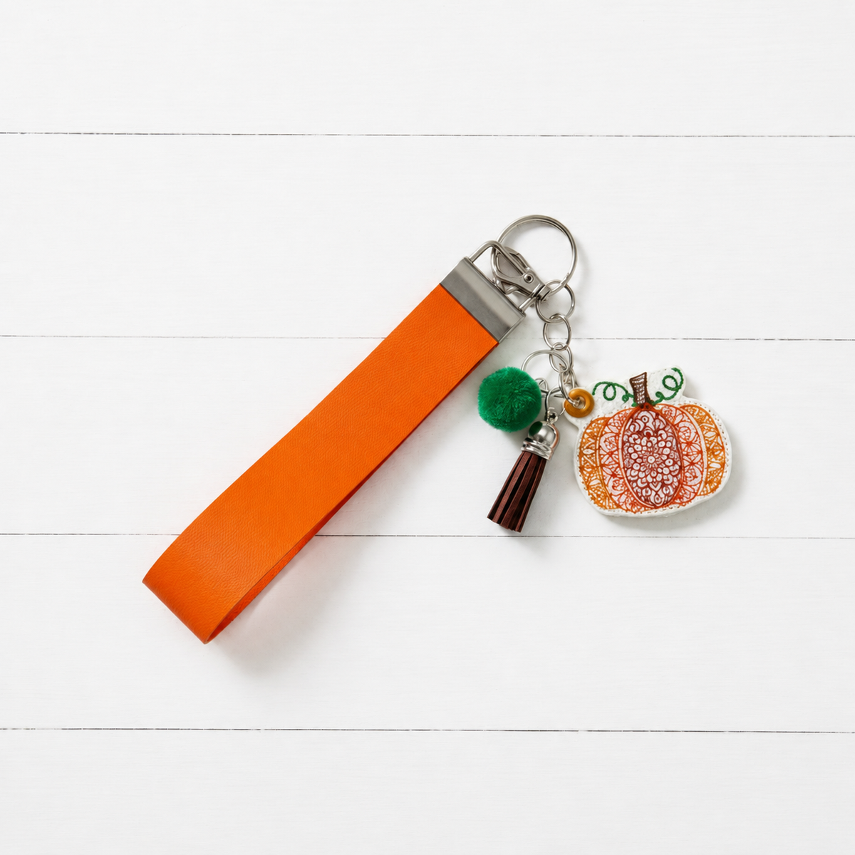 Embroidery Pumpkin Keychain and Wristlet — clean white wood primary image
