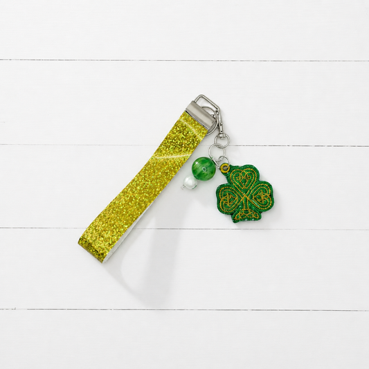 Gold Shamrock Keychain and Wristlet — clean white wood primary image
