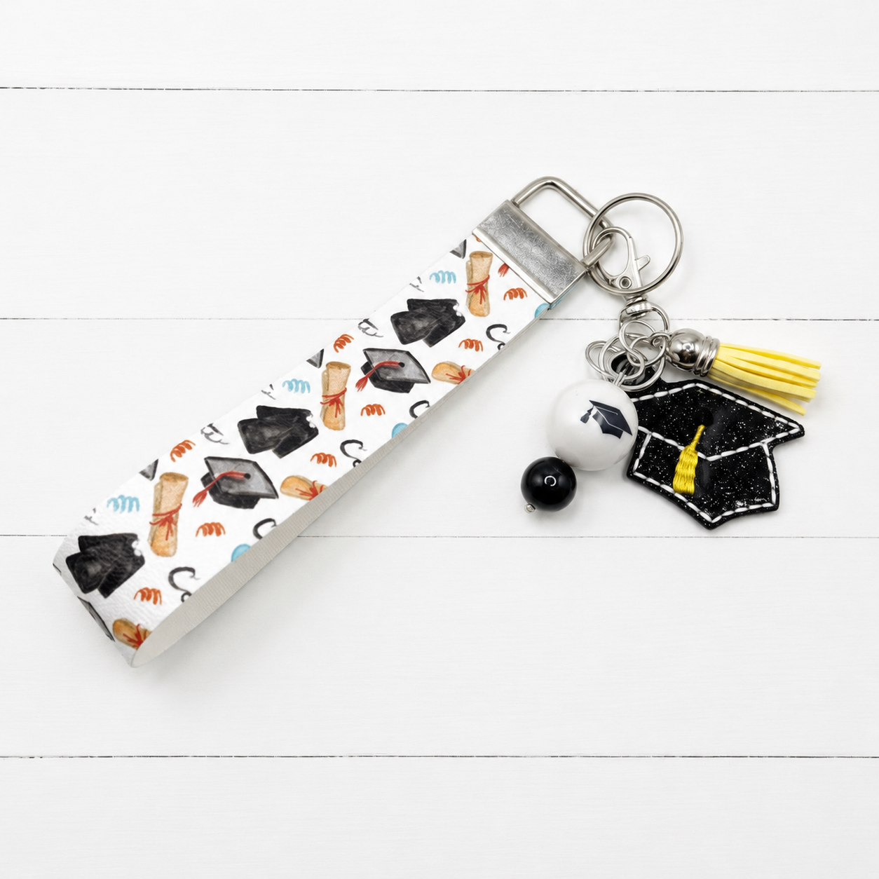 Graduation Keychain with Graduation Wristlet — clean white wood primary image