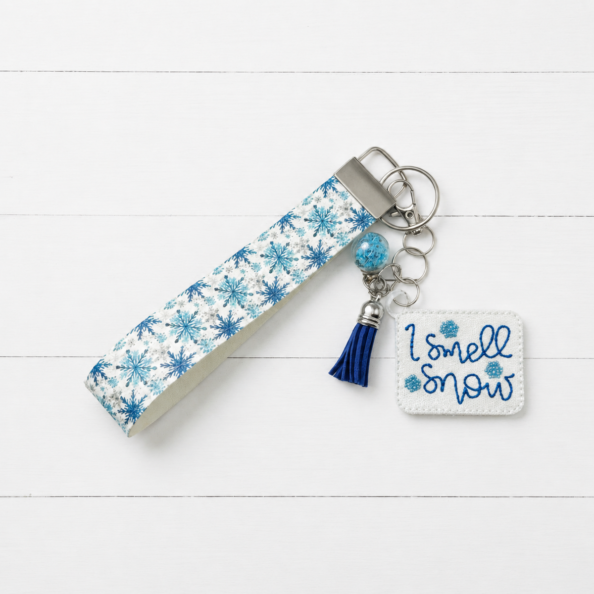 I Smell Snow Keychain and Wristlet — clean white wood primary image