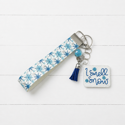 I Smell Snow Keychain and Wristlet — clean white wood primary image
