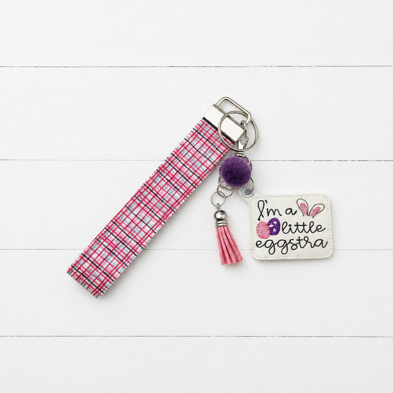 I’m a Little Eggstra Keychain and Wristlet — clean white wood primary image