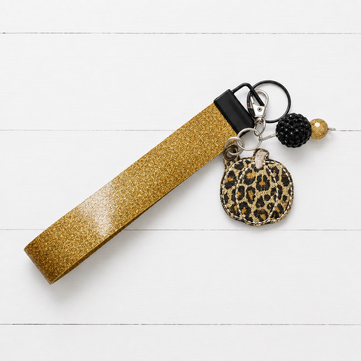 Leopard Pumpkin Keychain and Wristlet — clean white wood primary image