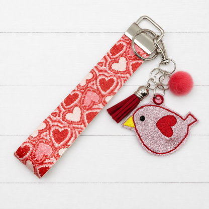 Love Bird Keychain and Wristlet — clean white wood primary image