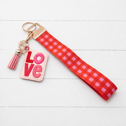 Love Keychain with Red and Pink Plaid Wristlet — clean white wood primary image