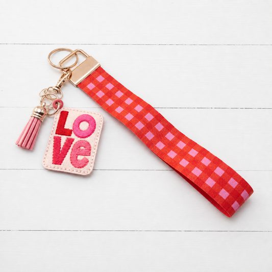 Love Keychain with Red and Pink Plaid Wristlet — clean white wood primary image