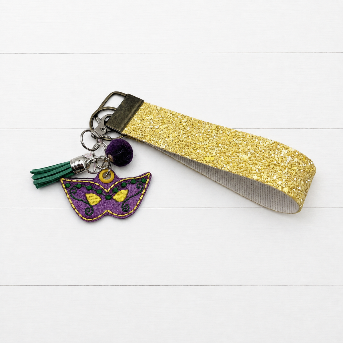 Mardi Gras Mask Keychain and Wristlet — clean white wood primary image