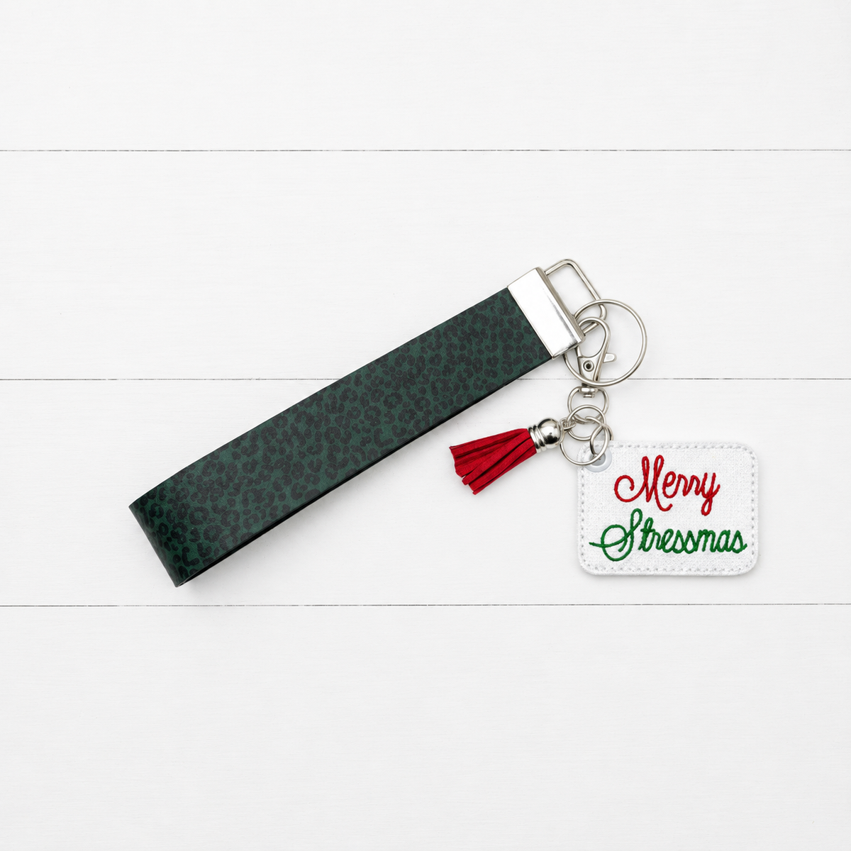 Merry Stressmas Keychain and Wristlet — clean white wood primary image