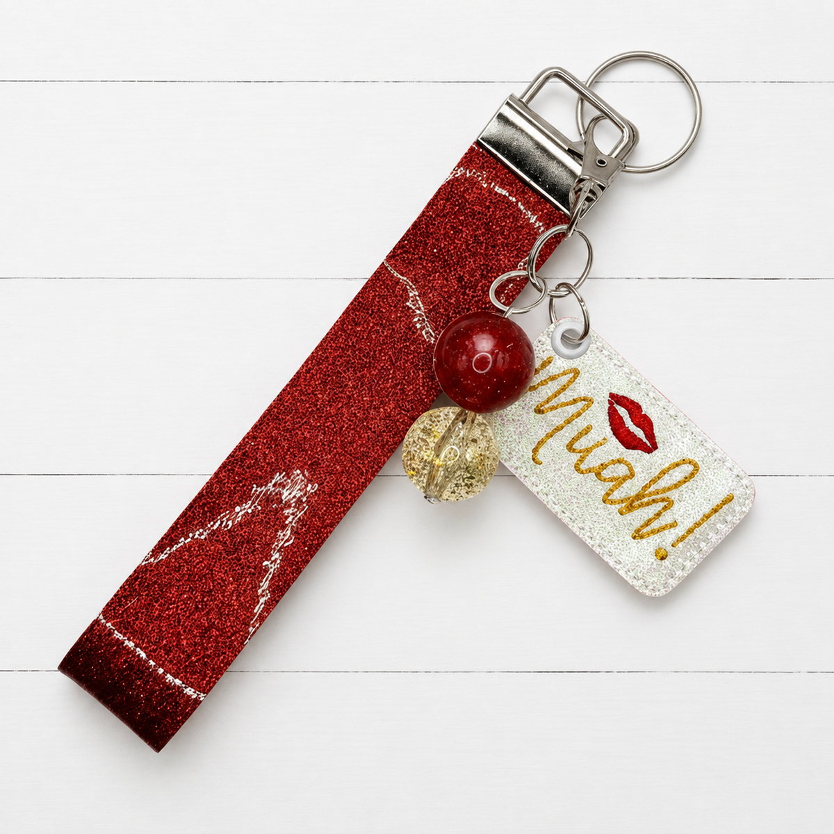 Muah! Kiss Keychain and Wristlet — clean white wood primary image