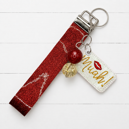 Muah! Kiss Keychain and Wristlet — clean white wood primary image