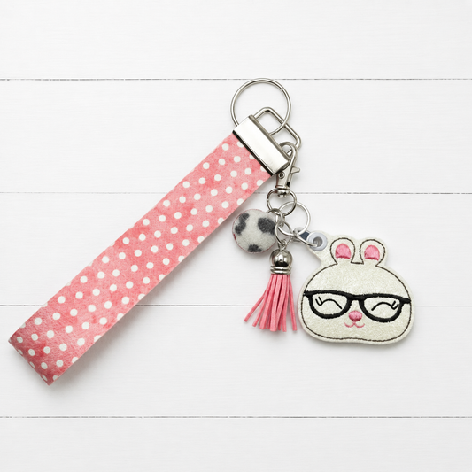 Needy Bunny Keychain and Wristlet — clean white wood primary image