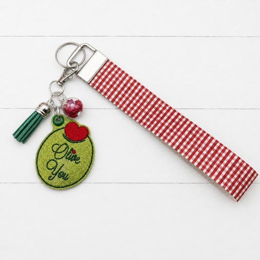 Olive You Keychain and Wristlet — clean white wood primary image