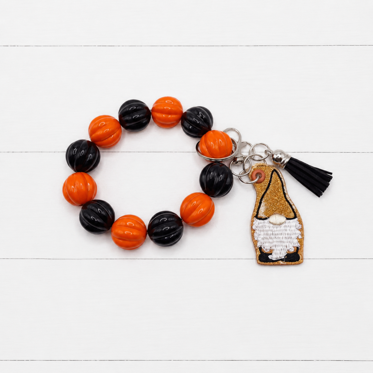 Orange and Black Gnome Keychain with Beaded Wristlet on clean white wood background