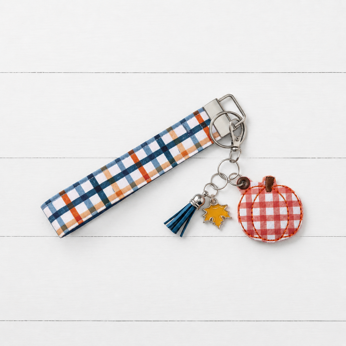 Orange Plaid Pumpkin Keychain and Wristlet on clean white wood background