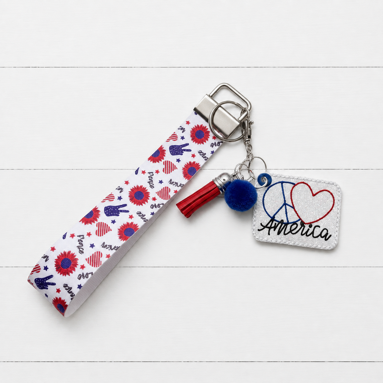 Peace, Love, America with wristlet on clean white wood background