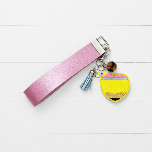 Pencil Heart Keychain and Wristlet on clean white wood background