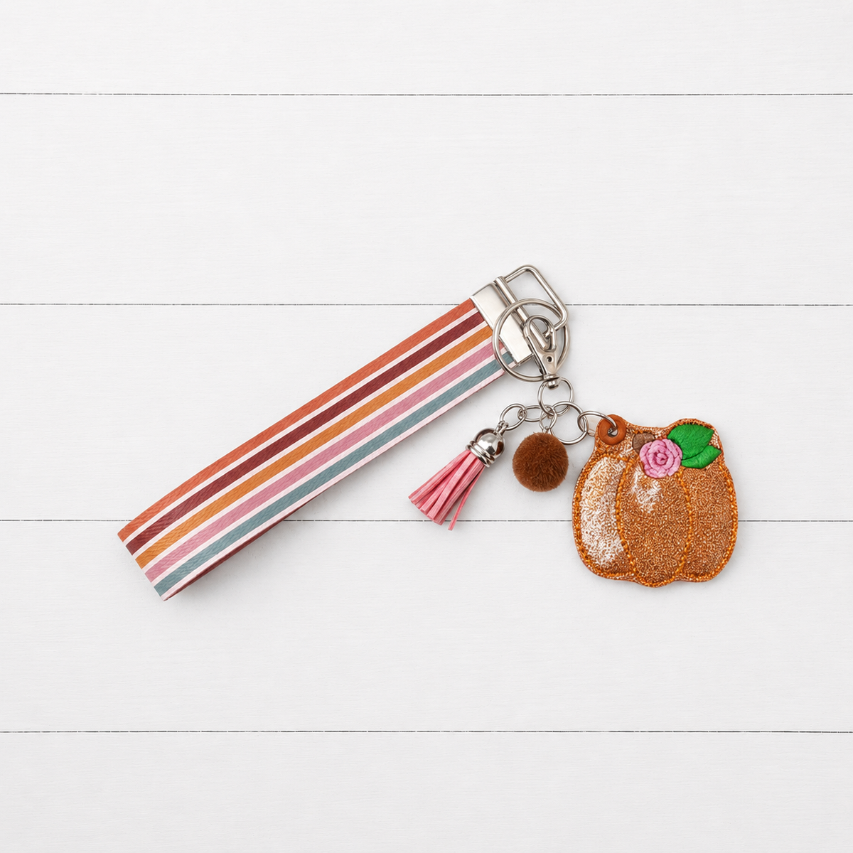 Pink Flower Pumpkin Keychain and Wristlet on clean white wood background