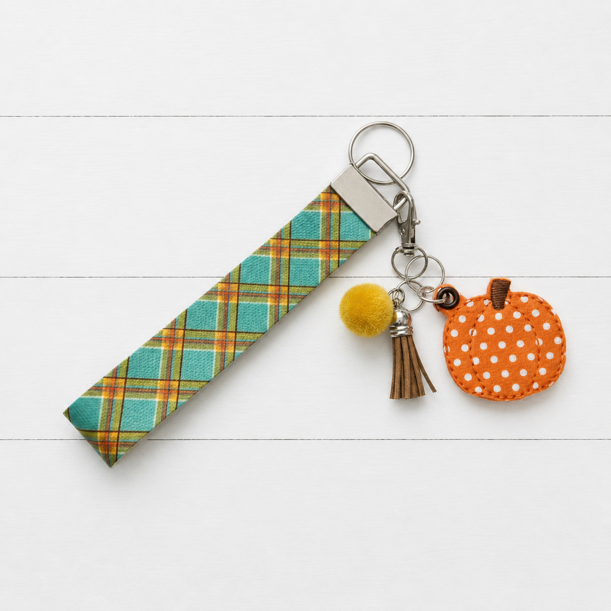 Polka Dot Pumpkin Keychain and Wristlet on clean white wood background