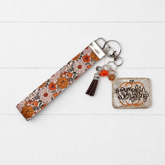 Pumpkin everything Keychain and wristlet on clean white wood background