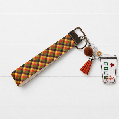 Pumpkin Spice Latte Cup Keychain and Wristlet on clean white wood background