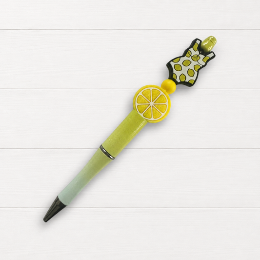 Lemon Swimsuit Beaded Pen on a clean white wood background