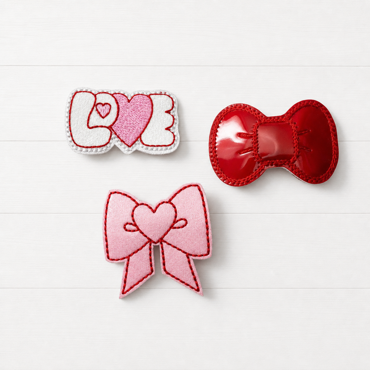 Love Hair Bow Clip Set on a clean white wood background