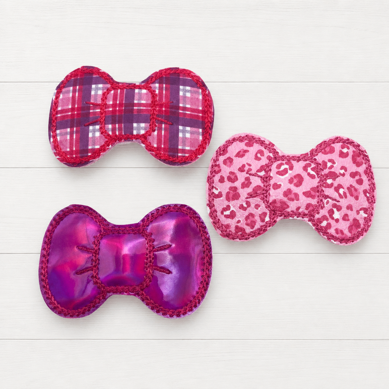 Pretty in pink hair clip set on a clean white wood background