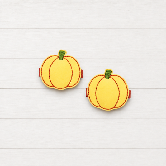 Glow in the dark Pumpkin Hair Clips on a clean white wood background
