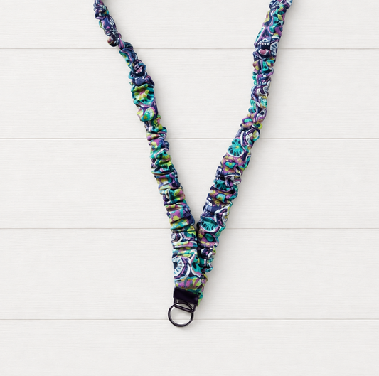 Purple Flower Power Scrunchie Lanyard on a clean white wood background