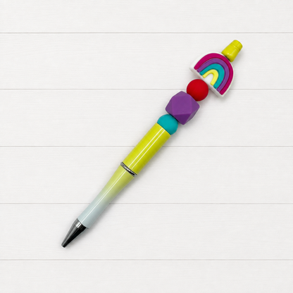Rainbow Beaded Pen on a clean white wood background