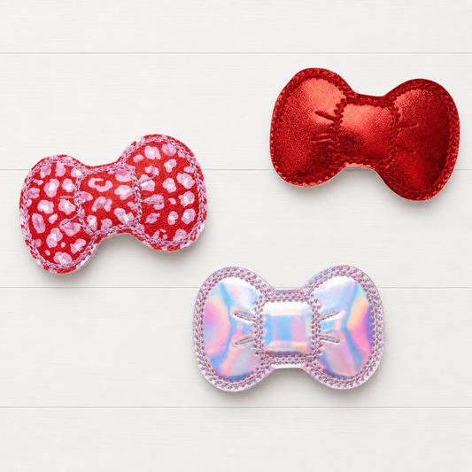 Red and Pink Leopard Hair Bow Clip Set on a clean white wood background