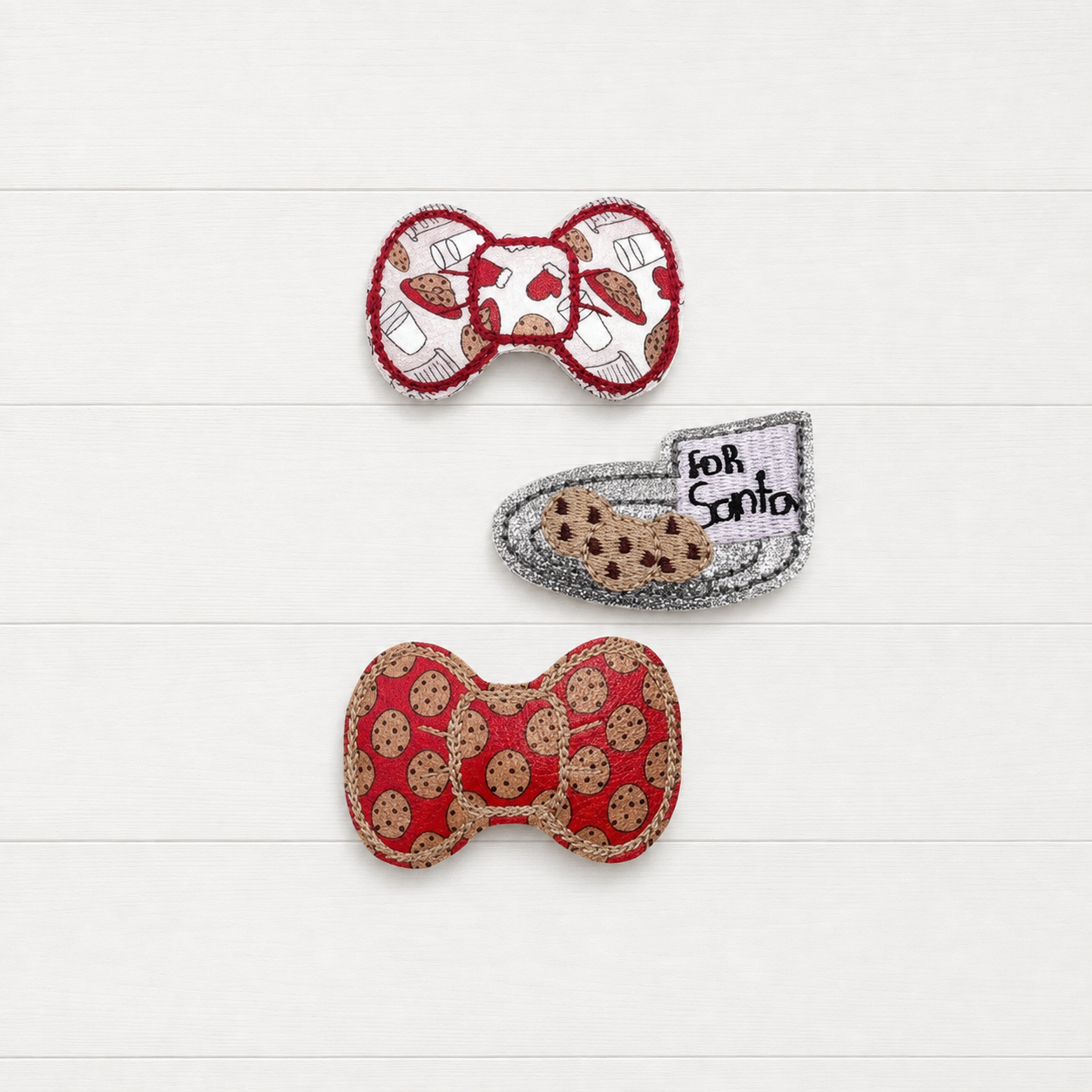 Santa cookies hair clip set on a clean white wood background
