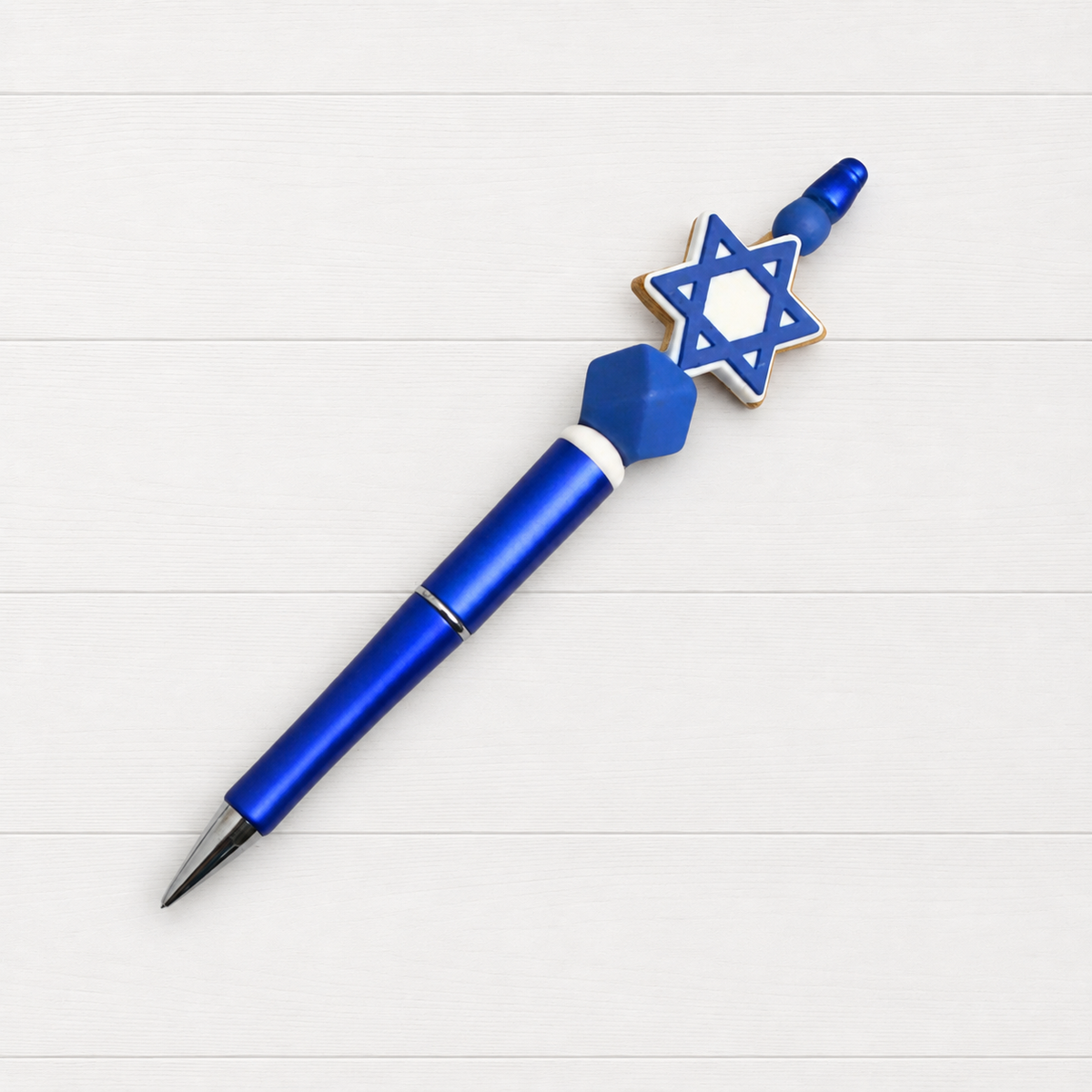 Star of David Beaded Pen on a clean white wood background