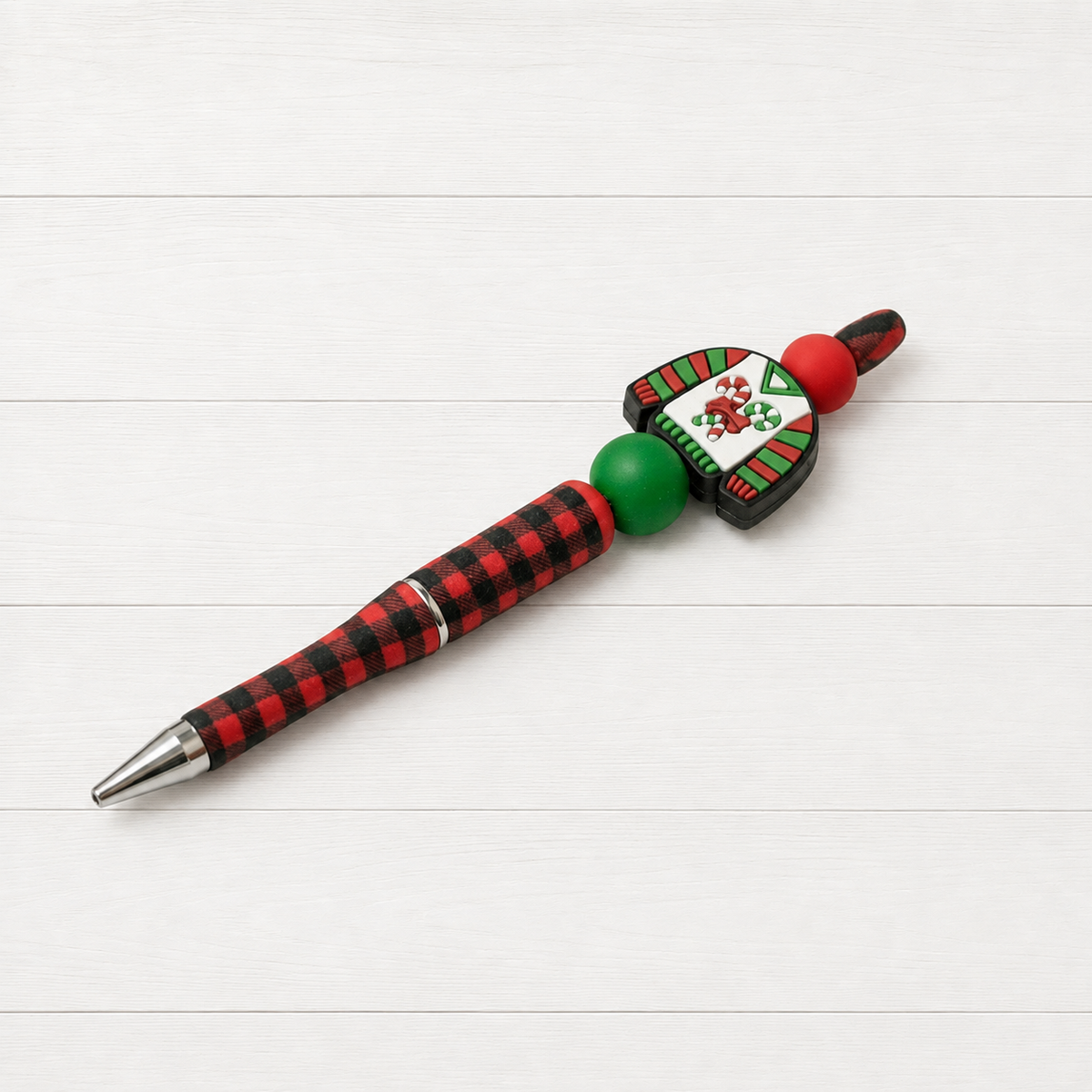 Ugly Christmas Sweater Beaded Pen on a clean white wood background